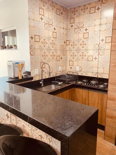 a kitchen with a sink and a counter top at Casa Pires - Sinop MT in Sinop