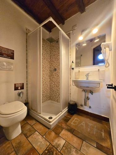 a bathroom with a shower and a toilet and a sink at Il Casale Di Roma in Prima Porta