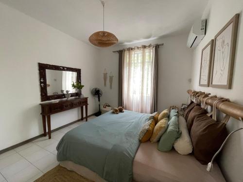 a bedroom with a bed and a mirror at Villa Evalia in Albion
