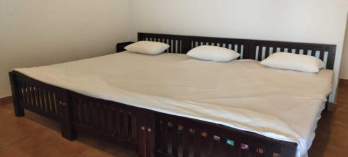 a bed with two pillows on top of it at Matha homestay Vattavada in Vattavada