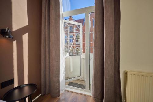 an open window with a view of a building at Quentin Museum Square Hotel in Amsterdam