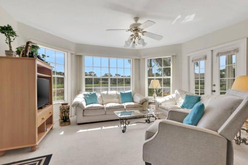 a living room with a couch and a tv at 4111 Gunnison Ct #1214 in Estero