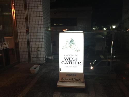 a sign in front of a west eatery at night at HOTEL CROWN HILLS FUJINOMIYA in Fujinomiya
