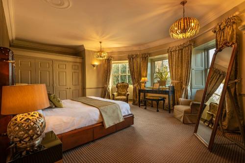 a bedroom with a bed and a desk in it at Washingborough Hall Hotel in Lincoln