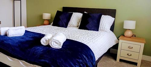a bedroom with a large bed with towels on it at Martindale Close - 3 Bedrooms - Sleeps 5 in Whitehaven