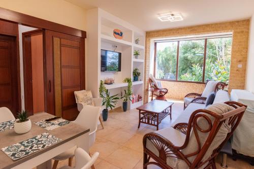 a living room with a table and chairs at Piale Palms Makenzie Beach Front Apartment Larnaca Airport Area in Larnaca