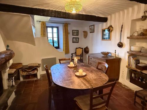 a kitchen with a large wooden table in a room at La Catounière - Maison de village avec magnifique vue in Mons