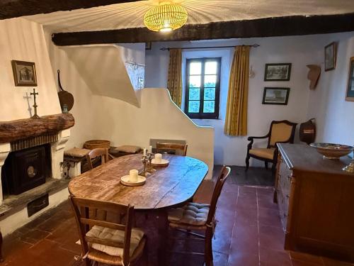 a dining room with a table and a fireplace at La Catounière - Maison de village avec magnifique vue in Mons