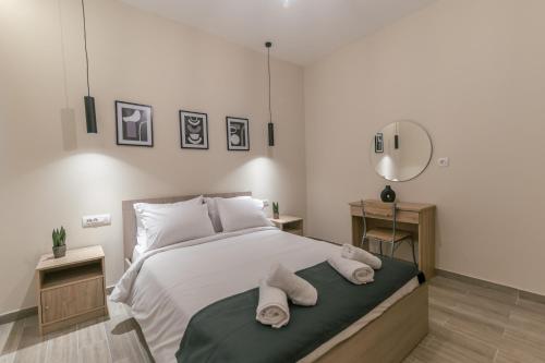 a bedroom with a bed with towels on it at Aurora apartments Room 1 in Marmari