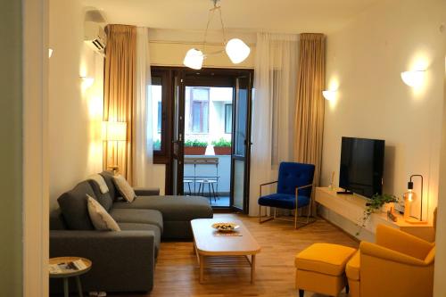 a living room with a couch and a tv at Spacious 3BR, 2BT with 5 balconies in Bucharest