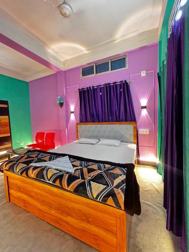 a bedroom with a bed with purple walls and purple curtains at Zen Garden Homestay in Jorhat