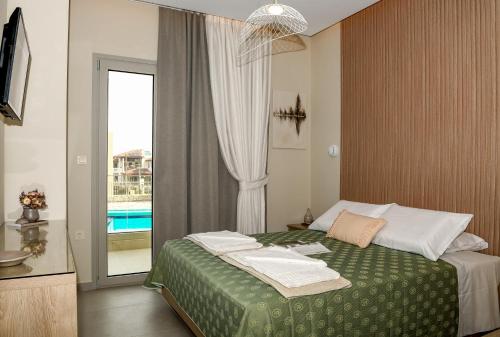 a hotel room with a bed and a window at Abelia Abode Apt in Kavros