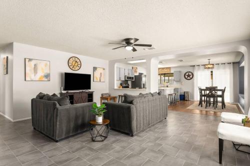 a living room with two couches and a tv at SeaCasa San Antonio in San Antonio