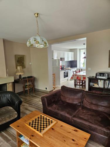 a living room with a couch and a table at Les Gîtes d'Argonne in Rarécourt