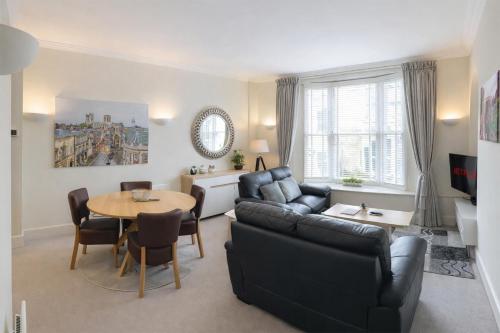 a living room with a couch and a table at Hunter House Holiday Apartment - York in York