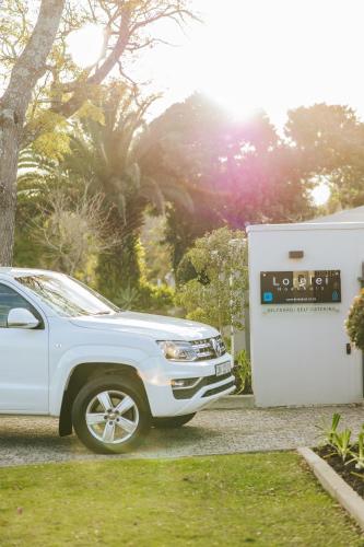 a white truck parked next to a gas pump at Lorelei Guest House in George