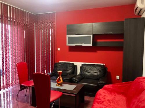 a red living room with a couch and a table at Joy City Stay Calea Timisoarei 4 in Timişoara