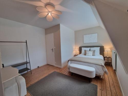 a bedroom with a bed and a ceiling fan at Au Mont Chez Nous # Jacuzzi & Sauna # in Pontorson