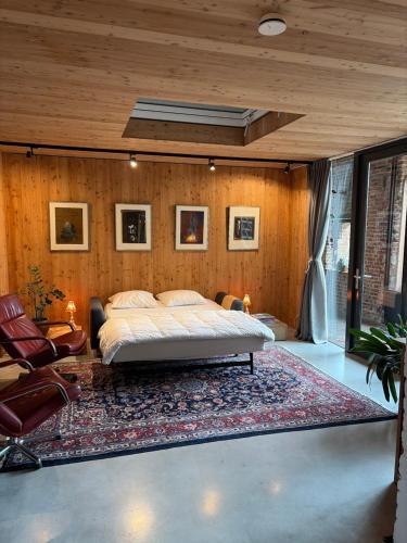 a bedroom with a bed and a large rug at Vakantiewoning in monumentale boerderij met yurt in Eckelrade