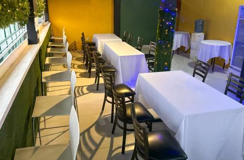 a row of tables and chairs in a restaurant at Master Universel Hotel Bar Restaurant in Cap-Haïtien