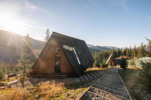 a small house sitting on top of a train track at УЛІС Ворохта in Vorokhta