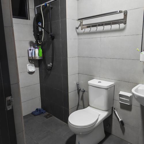 a bathroom with a white toilet and a sink at Eduscentral Stanford, Setia Alam in Shah Alam