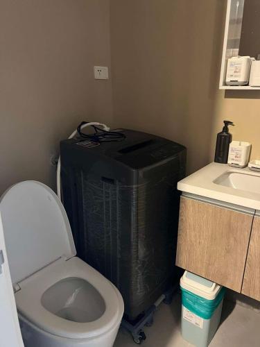 a small bathroom with a toilet and a sink at KEY REALTY SERVICES Ph in Pajak
