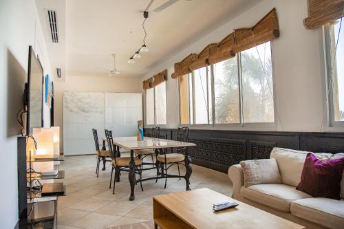 a living room with a table and a couch at Spacious 1 bedroom Apartment with Breathtaking Pool and Beach Views in Ras al Khaimah