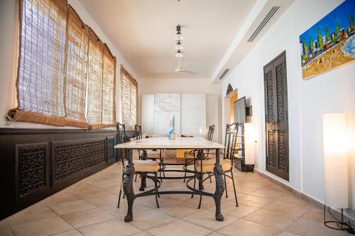 a dining room with a table and chairs at Spacious 1 bedroom Apartment with Breathtaking Pool and Beach Views in Ras al Khaimah