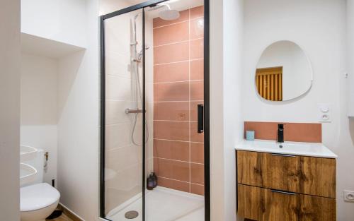 a bathroom with a shower and a sink and a toilet at Le Choeur in Rodez