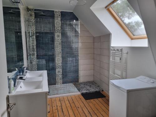 a bathroom with a shower and a sink at Au Mont Chez Nous # Jacuzzi & Sauna # in Pontorson