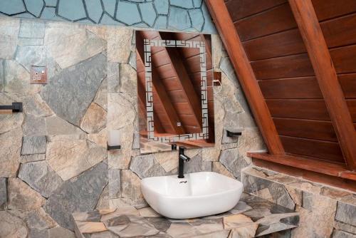 a bathroom with a sink in a stone wall at Gimanhala Thisawewa in Anuradhapura