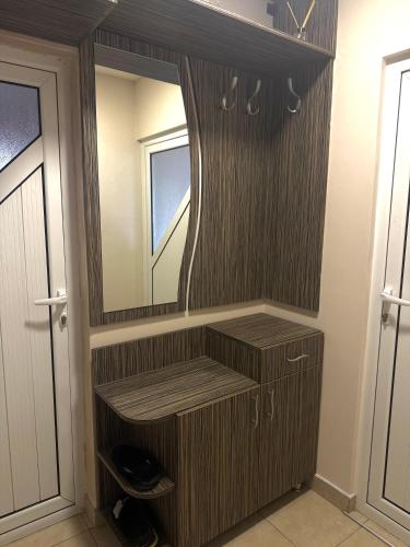a bathroom with a vanity with a mirror at Apartment Rozen in Varna City