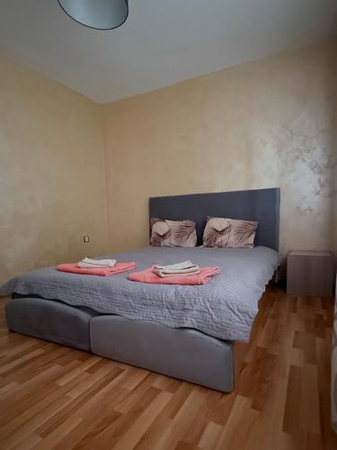 a bedroom with a bed with two towels on it at Apartment Rozen in Varna City