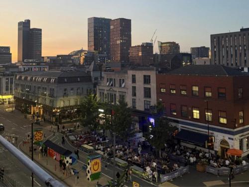 an aerial view of a city with a crowd of people at napNQ in Manchester
