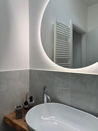 a bathroom with a white sink and a mirror at Appartamenti Lilla in Tremosine Sul Garda