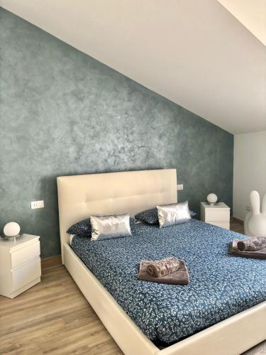 a bedroom with a large bed with blue sheets at Appartamenti Lilla in Tremosine Sul Garda