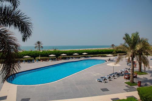 an overhead view of a swimming pool at a resort at Spacious 1 bedroom Apartment with Breathtaking Pool and Beach Views in Ras al Khaimah