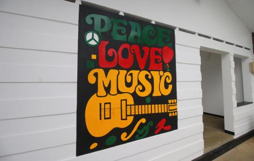 a banner hanging on a wall in a room at Backpack Beach Hostel & Reggae Bar in Galle