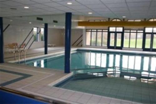 a large swimming pool in a large building at 't Behouden huys in Hollum