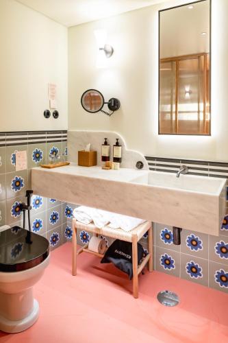 a bathroom with a large sink and a toilet at Artcore Hotel Porto in Porto