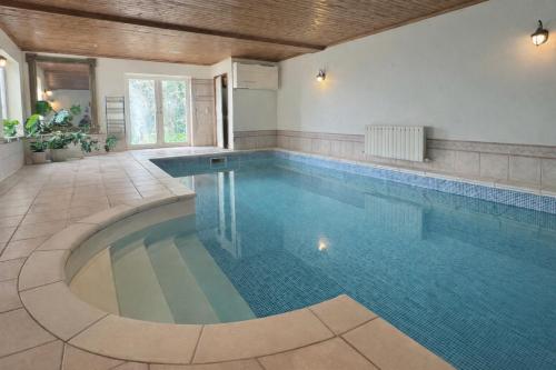 a large swimming pool in a house with at Lamack Vale House, Tenby, 5 Bedrooms with Private Heated Indoor Swimming Pool & Parking in Tenby