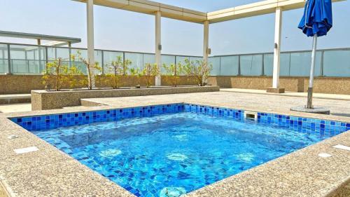 a swimming pool on top of a building at Charming Hideaway Studio with Cozy Views in Ras al Khaimah