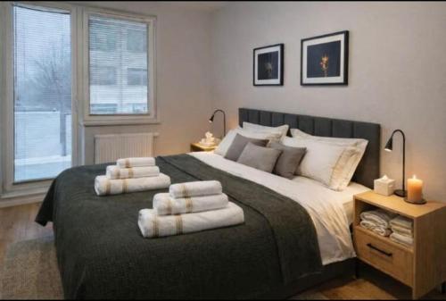 a bedroom with a large bed with towels on it at APARTAMENT FLOW Walendów in Walendów