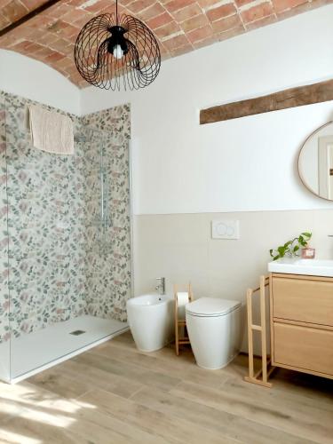 a bathroom with a toilet and a sink at B&B Barba Vigin in San Damiano dʼAsti