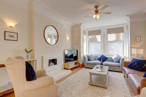 a living room with a couch and a tv at Fabulous Seaside Retreat in Hunstanton