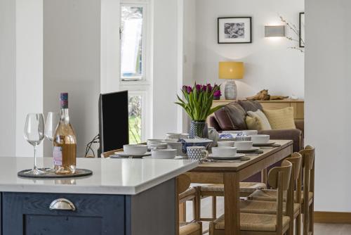 a living room with a table and a couch at Cedar Barn in Chichester