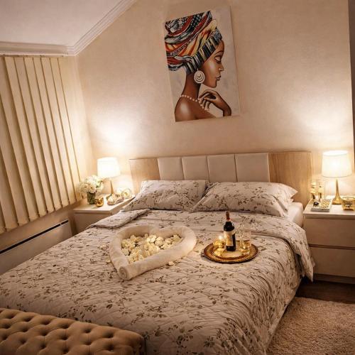 a bedroom with a bed with a tray of food on it at Apartman Dionis SM in Sremska Mitrovica