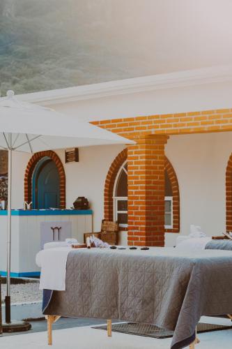 a room with a table and an umbrella at Casa Arcos Tepoztlán in Tepoztlán