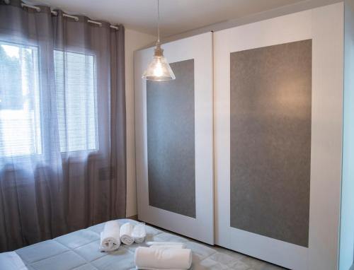 a bedroom with a bed with towels on it at Borgo Dei Cedri in Bari